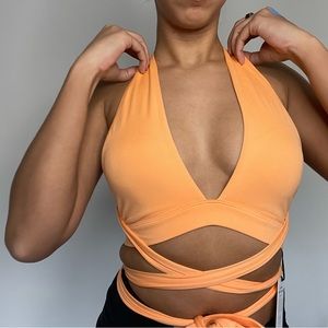 ALO YOGA *With Tags* Alosoft Switch It Up bra in a creamy orange color.